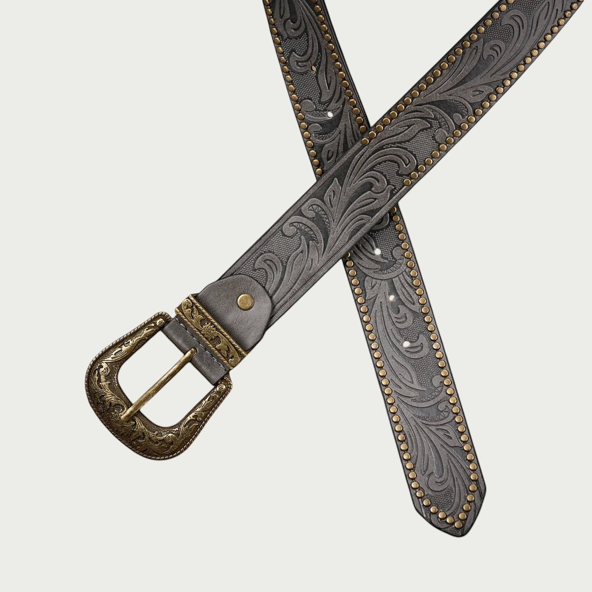 Ceinture Ceintura Concordia grise croisée montrant le gaufrage floral et la bordure cloutée dorée