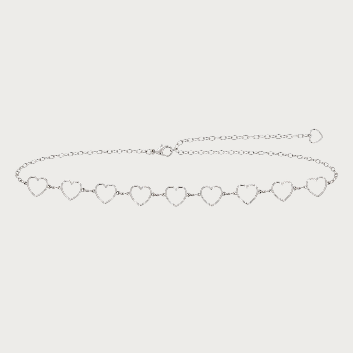 Ceinture chaîne Ceintura argentée à maillons cœurs avec sa chaînette de réglage déployée sur toute la longueur