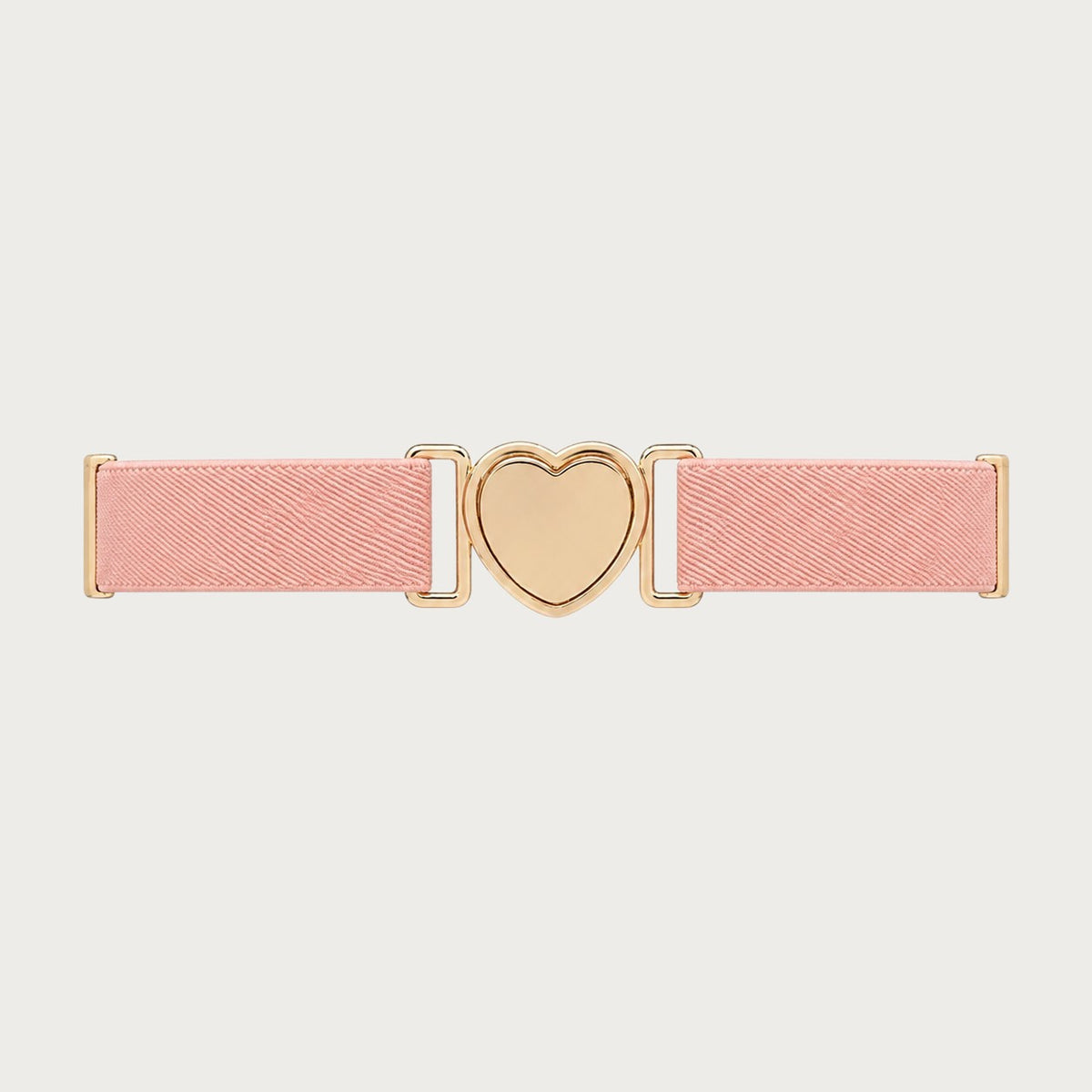 Gros plan sur la boucle dorée en forme de cœur de la ceinture élastique rose Ceintura pour fille