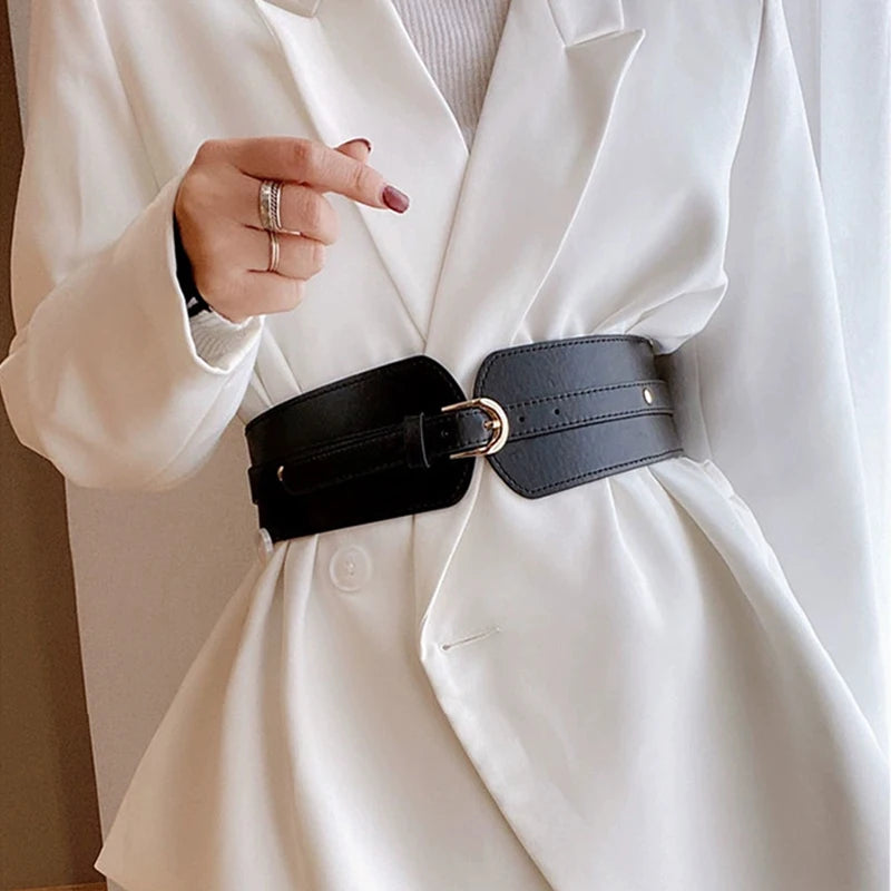 Ceinture large taille haute Ceintura Urbino en similicuir noir avec boucle dorée en D sur un blazer blanc